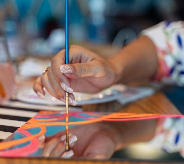 Decorative mirror with hand-painted colorful borders made in an art session in Abu Dhabi.