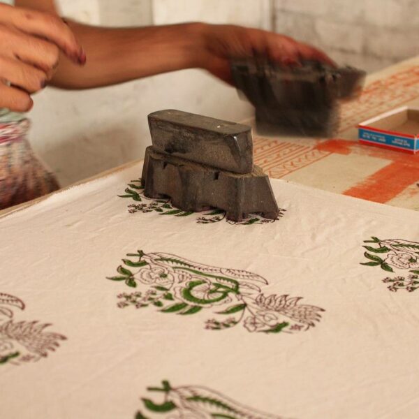 Participant carving a linocut design for a printmaking workshop in Abu Dhabi.