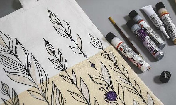 Hand-painted cotton tote bag with floral and abstract designs created in a workshop in Abu Dhabi