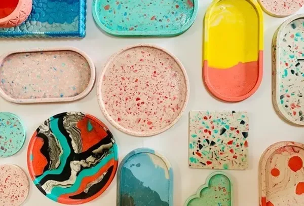 Colorful Jesmonite coasters and trays created during a hands-on art workshop in Abu Dhabi.